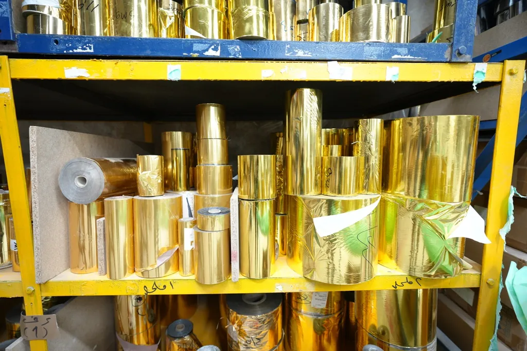 Rolls of gold metallic material in the Etalex stockroom